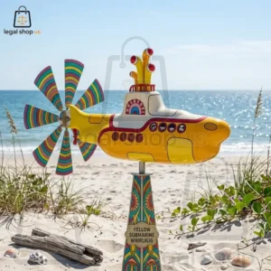 A decorative Yellow Submarine garden whirligig displayed on a beach.