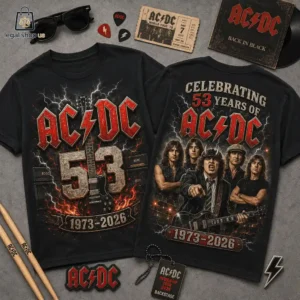 Two black AC/DC band anniversary graphic t-shirts displayed with rock-themed memorabilia