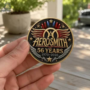 Aerosmith 56th Anniversary Commemorative Challenge Coin Hand holding a commemorative Aerosmith 56 years anniversary coin