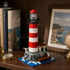A detailed brick-built model of a red and white lighthouse on a coastal base with seagulls.