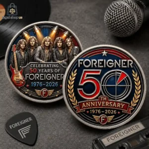Two commemorative metal coins celebrating the 50th anniversary of the rock band Foreigner, featuring the band members and iconic branding.