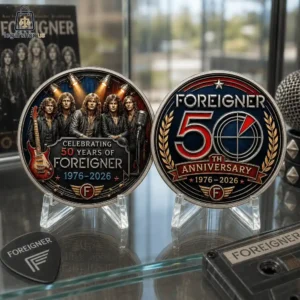 Two commemorative Foreigner 50th anniversary coins displayed on stands with music-themed memorabilia.