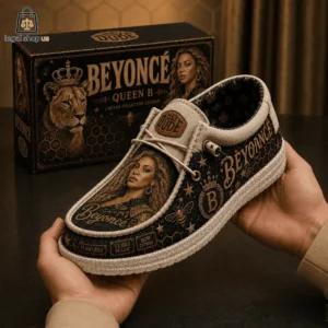 Beyoncé Queen B I'm That Girl Hey Dude Loafer Shoes Person holding a limited edition Beyonce themed Hey Dude shoe in front of its collector box.