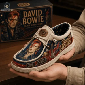 Person holding a Hey Dude slip-on shoe featuring David Bowie art and Ziggy Stardust branding