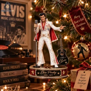 Elvis Presley commemorative Christmas tree ornament featuring him in a white jumpsuit with a microphone and guitar.