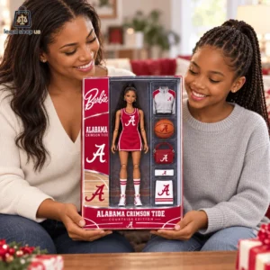 A woman and a young girl holding an Alabama Crimson Tide Barbie doll set in its packaging.