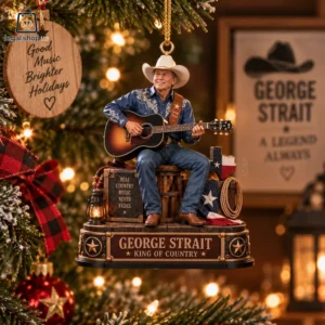 George Strait figurine Christmas tree ornament playing acoustic guitar on a wooden crate base.