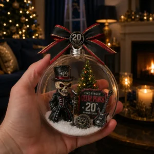 Five Finger Death Punch 20Th Anniversary Globe Ornament Hand holding a Five Finger Death Punch 20th anniversary Christmas ornament with a skeleton mascot inside.