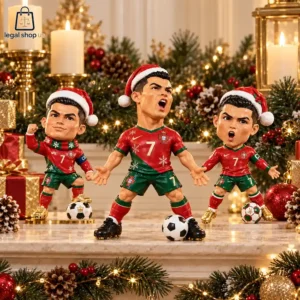 Three Cristiano Ronaldo figurines wearing Santa hats and Portugal football kits with soccer balls on a holiday fireplace mantel