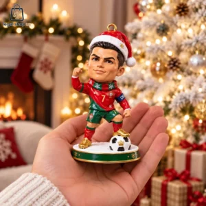 Cristiano Ronaldo Christmas ornament held in a hand with holiday decor background