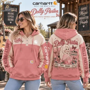 Woman wearing a Carhartt Dolly Parton pink and cream hoodie with western-inspired graphics.